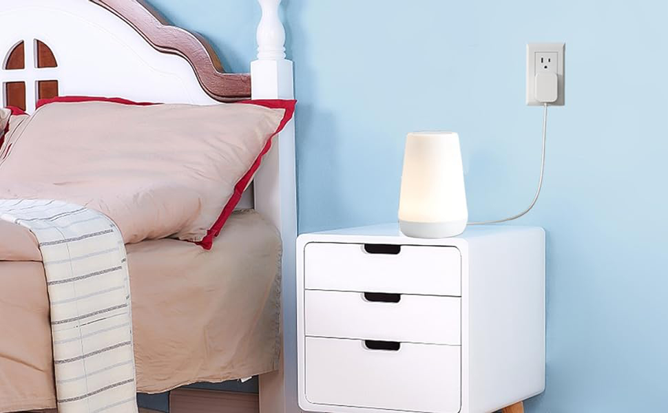 On the bedside table, the power cord is charging the Hatch Sound Machine.