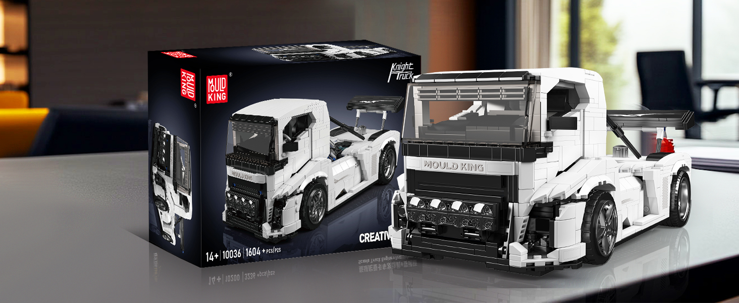 White toy truck models, including packaging box and assembled detailed scale model truck on display surface.