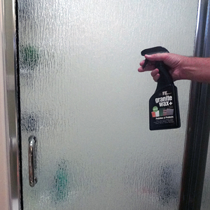 spraying shower door, cleaning bathroom