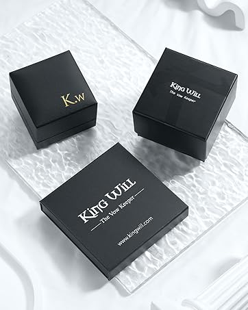 Three black jewelry boxes on a textured surface. Two smaller boxes labeled 'K+W' and 'King Will', and one larger box with 'King Will' and website text visible.