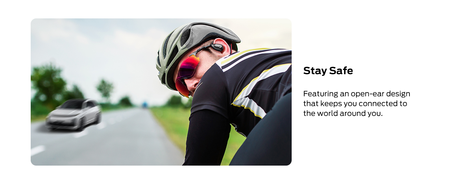 a man wearing a helmet and sunglasses, leaning on a road bike.