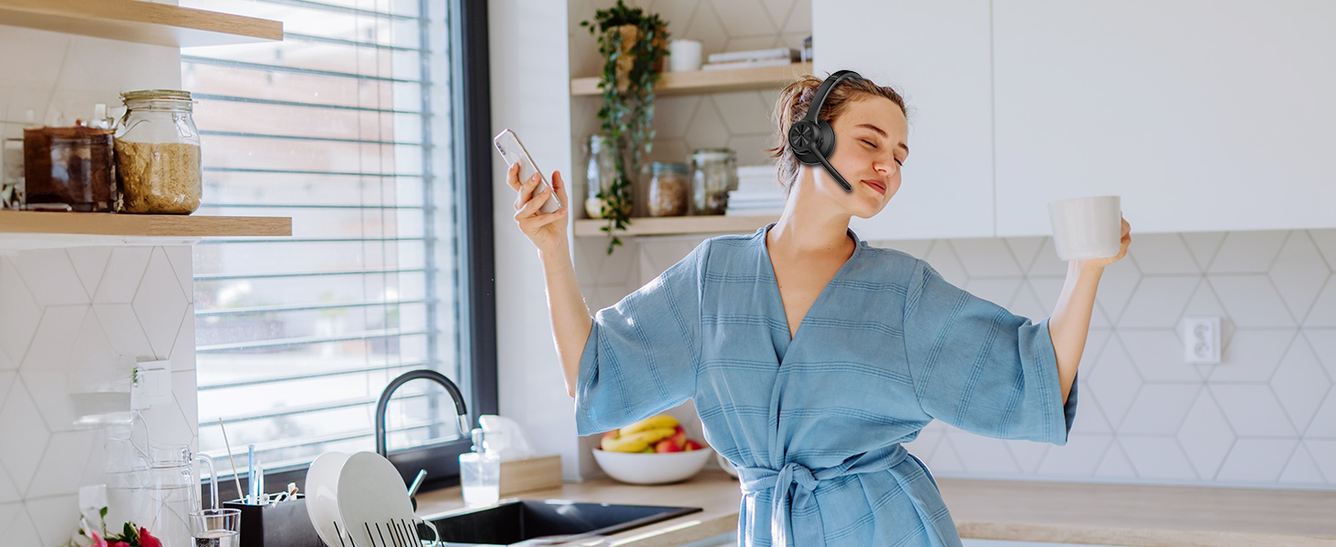 Person in blue robe dancing in kitchen setting, with counter and shelving visible in background.