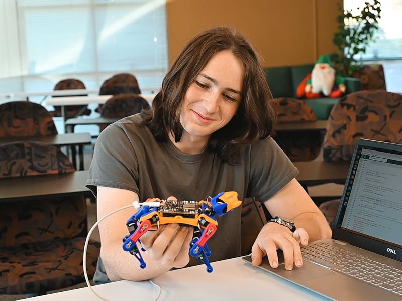 male teenager play quadruped programmable dog petoi bittle robot coding Python C++ programming