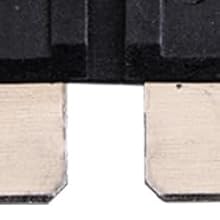 Close-up of two beige, rectangular electronic connectors or terminals with metallic contacts, mounted on a black surface or circuit board.