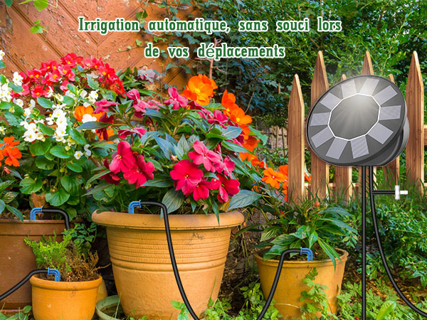 سیستم آبیاری خودکار باغ با واحد کنترل خورشیدی، در باغی با گلهای گلدانی رنگارنگ نشان داده شده است