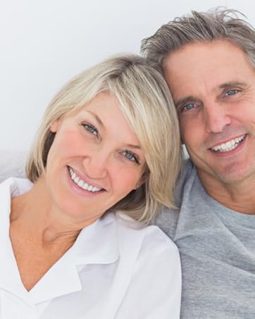 man and woman couple roughly 40 years old smiling at the camera