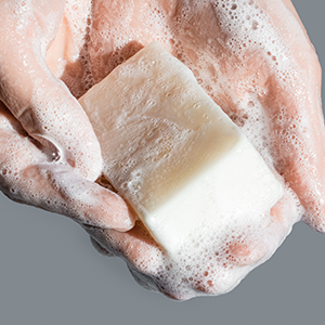 Wet soap bar, work into a lather, wash and then rinse.