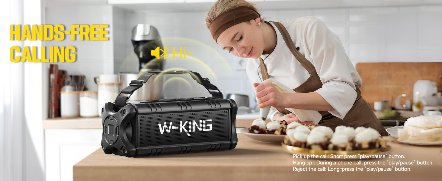Black portable speaker or audio device labeled W-KING shown on wooden surface in kitchen setting with hands-free calling feature highlighted.