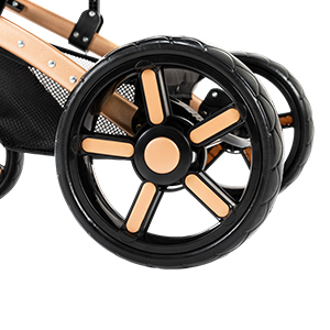 Large black wheel with five-spoke wooden design insert, likely part of a stroller or pushchair. Black fabric or mesh visible above the wheel.