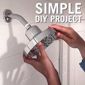 Image of woman&#39;s hands installing a shower head onto a standard shower arm