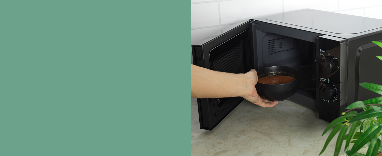 image of soup being placed into the microwave 