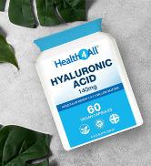 White bottle of hyaluronic acid supplements on a white surface with green leaves. Label shows 60 capsules, vegan-friendly, and made in the USA.