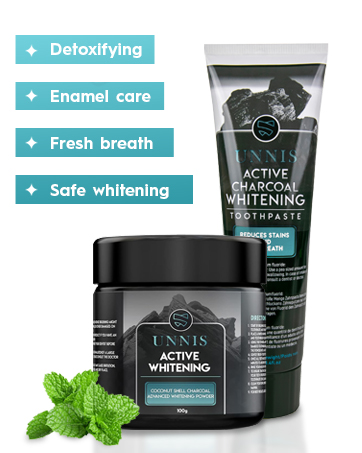 Two dental products: a charcoal whitening toothpaste tube and an active whitening powder jar. Features include detoxifying, enamel care, fresh breath, and safe whitening. Mint leaves visible.