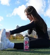 Protein sports drink with athlete stretching in the background