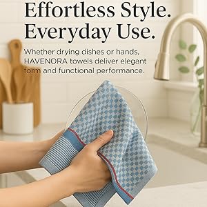 Hands holding blue patterned 100% cotton kitchen towel with flat weave and hanging loop