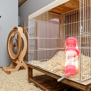 A cozy pet habitat with a wooden house and a soft bedding area, showcasing the product in use.