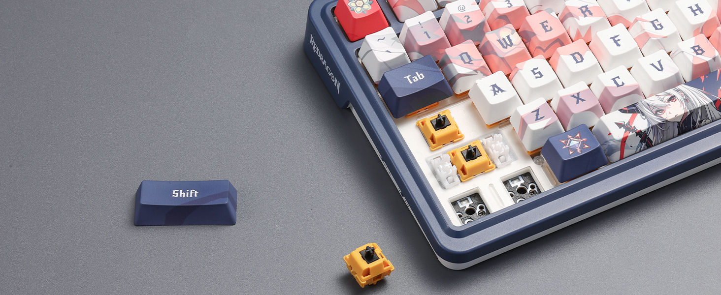 Mechanical keyboard with colorful keycaps. One blue key and one yellow key are detached and sitting next to the keyboard.