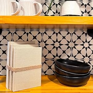 Beige decorative book stack on shelf in modern kitchen decor.