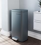 Gray rectangular pedal bin with a lid, positioned in a corner next to a white cabinet on a wooden floor.