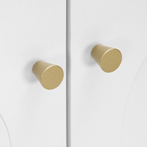 Two gold-colored cylindrical door or drawer knobs mounted on a white surface, showcasing a minimalist hardware design.