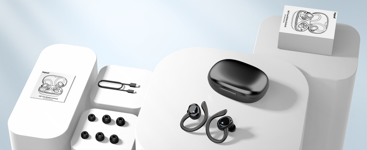 Wireless earbuds display with charging case and retail packaging boxes arranged on a light gray surface.