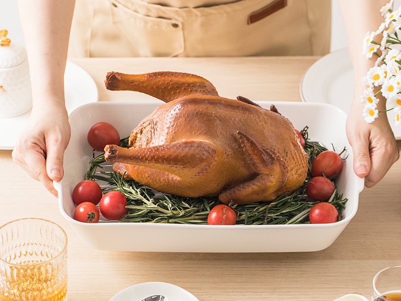 hands holding a baking dish