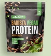 Le texte indique « BARISTA VEGAN PROTEIN ». Sachet refermable noir avec accents verts contenant de la poudre protéinée végétalienne.