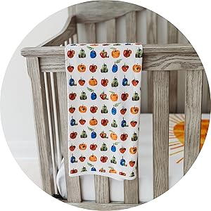 close up image of blanket draped over wooden crib