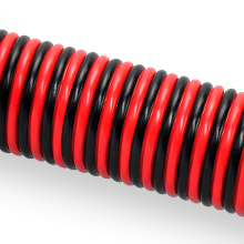 Flexible corrugated tubing with alternating black and red spiral pattern, shown at an angle against white background.