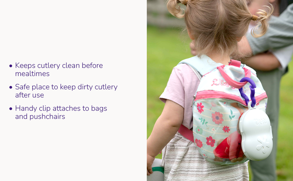 Blonde toddler girl wearing a backpack that has a doddl toddler cutlery travel case clipped to it