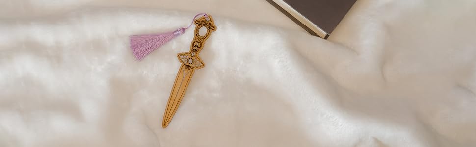 Dagger wooden bookmark on white background