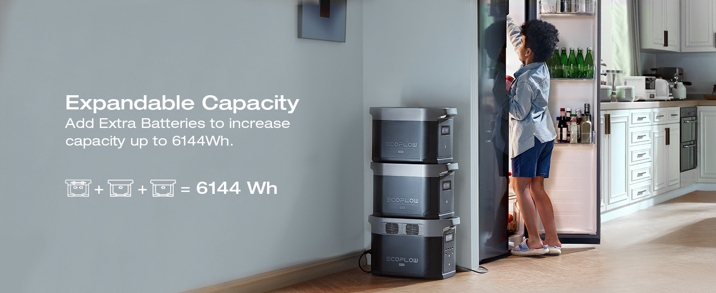 a man walking past a wall with a stack of three portable battery chargers.