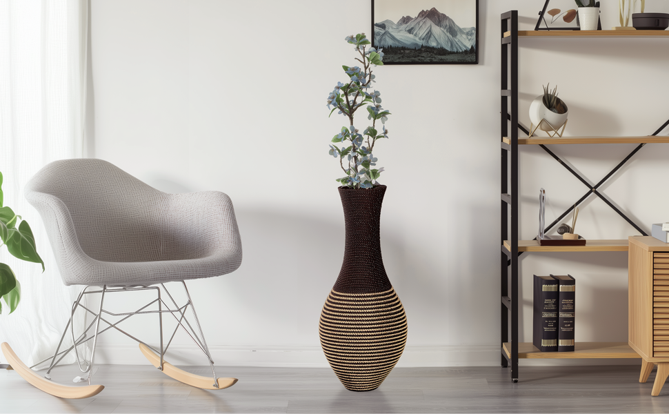 Grey rocking chair, tall woven vase with plant, shelf with decor/books, and mountain - framed pic