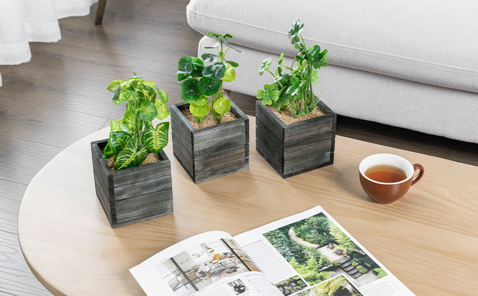 faux plants in grey wooden planter boxes