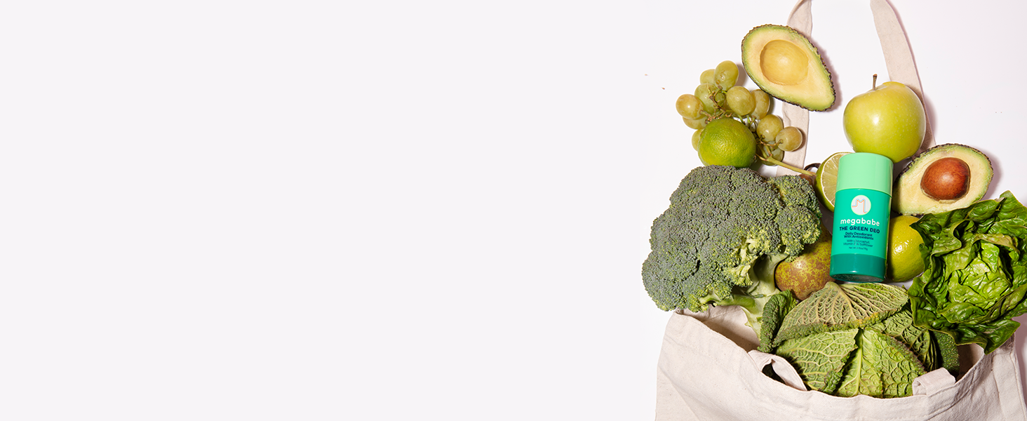 Megababe green deo in a bed of different green vegetables.