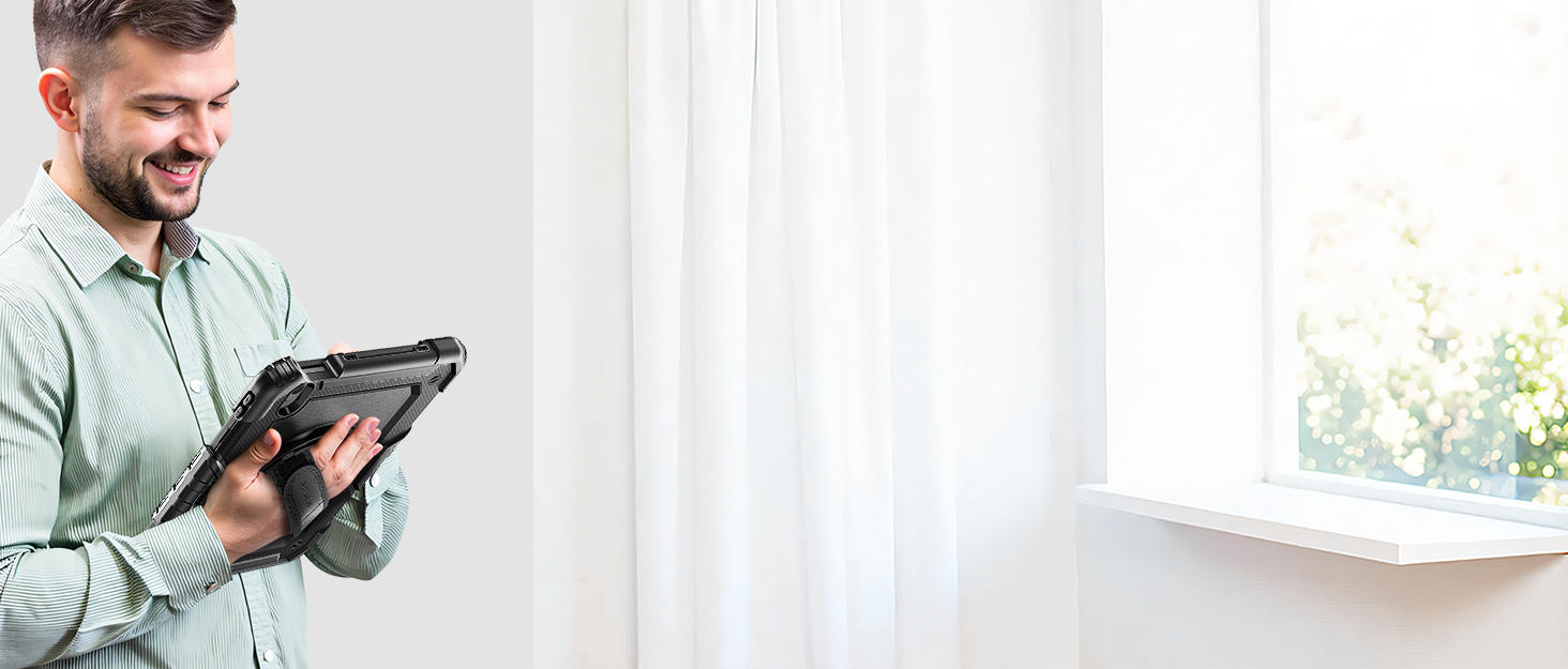 Personne tenant une tablette numérique près d'une fenêtre avec des rideaux blancs.