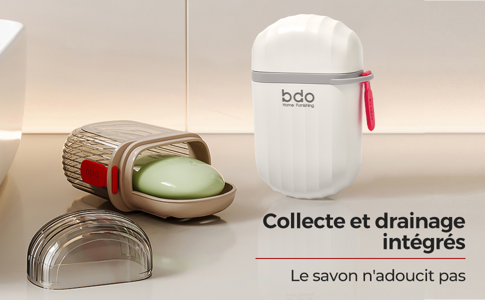 avec évacuation et porte-savon intégré. Comprend une base bronzée avec des crêtes, du savon vert et une couverture transparente. Récipient blanc avec sangle rouge à proximité.