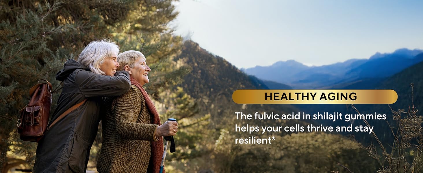 Two women in coats with walking sticks  in forest enjoying the view with healthy aging text