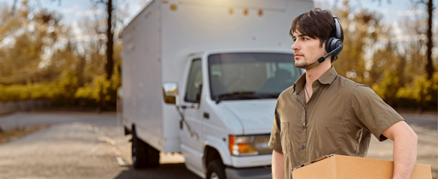 Outdoor scene with delivery truck parked in autumn setting.