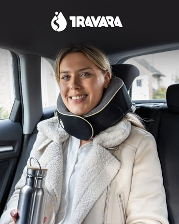 Text reads: 'TRAVAYA'. Interior vehicle shot showing person in white fleece jacket with headphones in car seat.