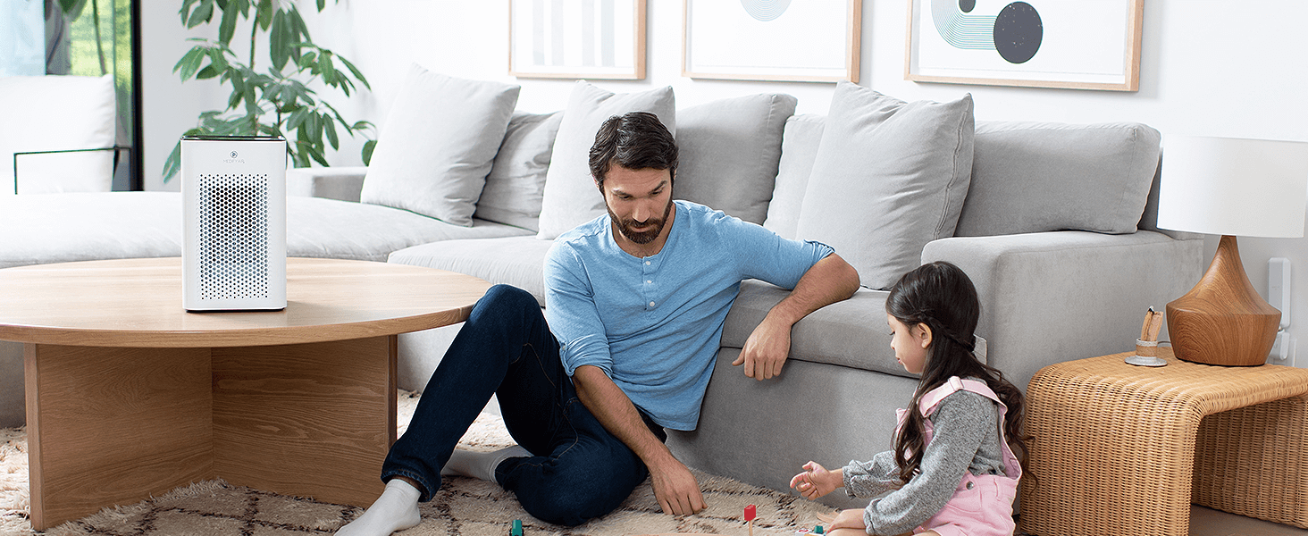 Father and daughter in the living room next to a white MA-25 air purifier