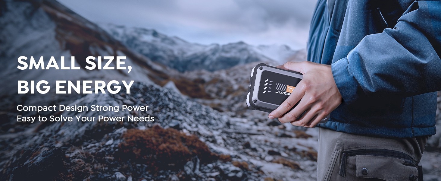 Compact portable power bank held in a hand outdoors. Device has LED indicators and appears rugged, suitable for outdoor use in rocky terrain.