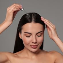 castor oil being applied to scalp