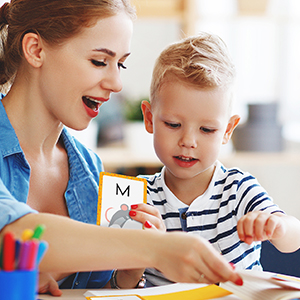 A teacher working with a student, using cards from the Early Learning Flash Card Set