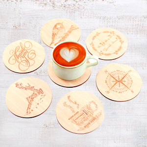 Wood chips printed with pictures of deer, compass, flying birds, etc. are used as coasters
