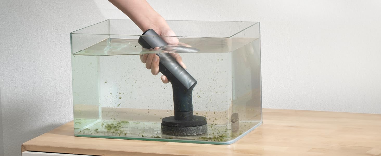 Gray handheld device submerged in a clear glass tank filled with water, demonstrating waterproof capabilities. Device appears to be in operation underwater.