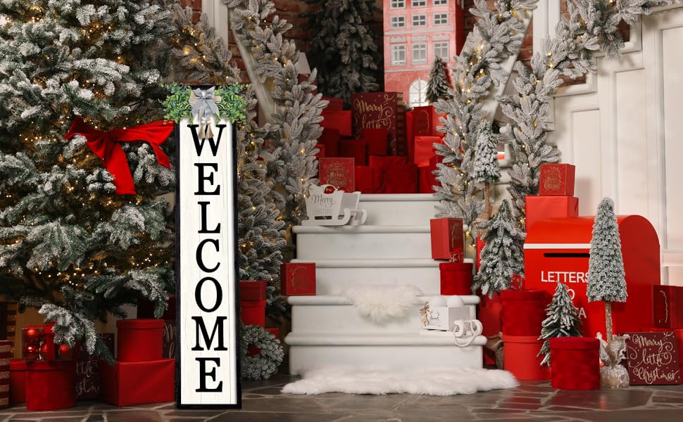 A festive Christmas scene with a &#34;WELCOME&#34; sign, snow-dusted trees, red gifts, and lit decorations.