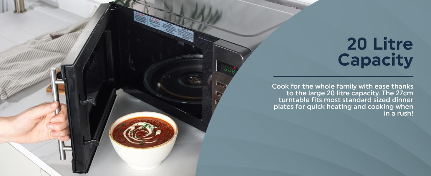 A person opening a microwave with a bowl of soup on the kitchen countertop