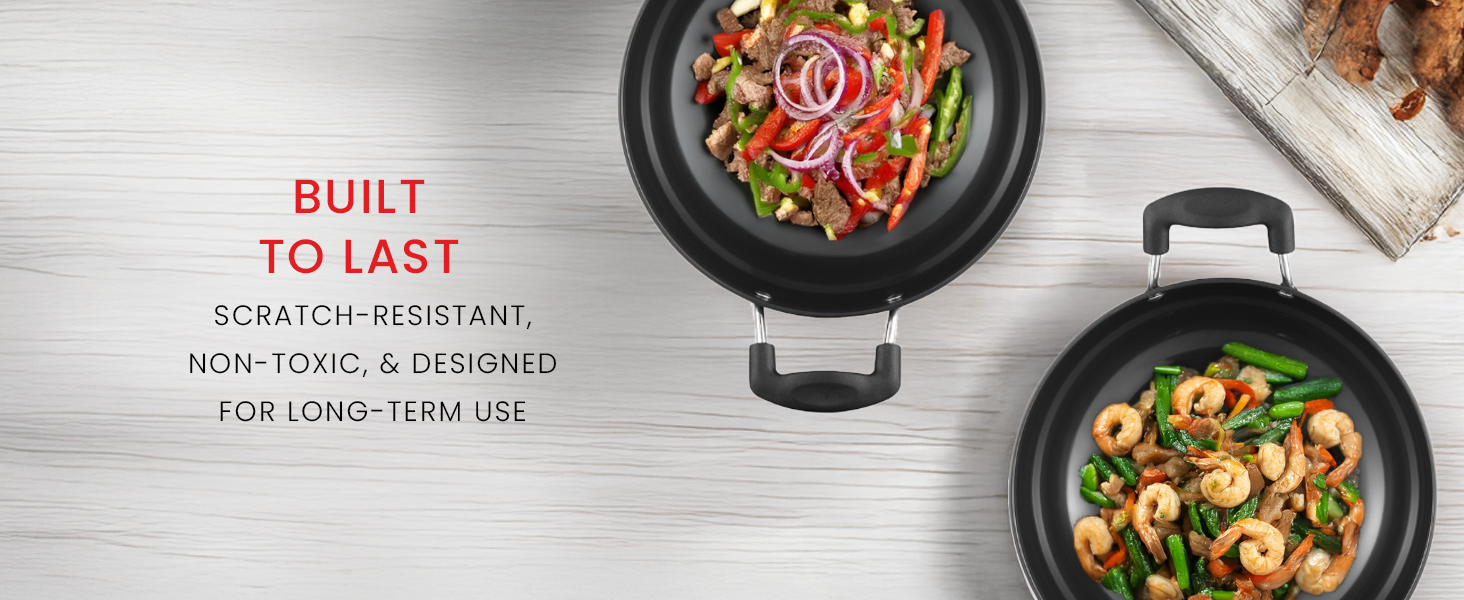Two black non-stick cooking pans with handles shown from above, containing stir-fried vegetables and meat. Text indicates scratch-resistant and non-toxic properties.