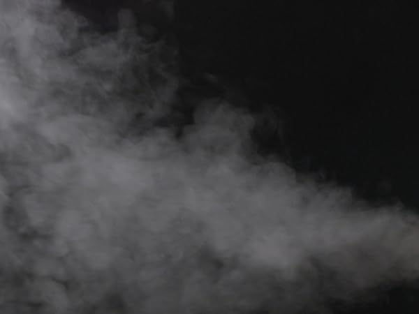 Ergonomic steam nozzle delivering powerful steam on a black dress blazer, removing wrinkles fast.